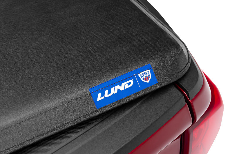 Lund 04-15 Nissan Titan (5.5ft. Bed) Hard Fold Tonneau Cover w/Bracket Kit - Black -  Shop now at Performance Car Parts